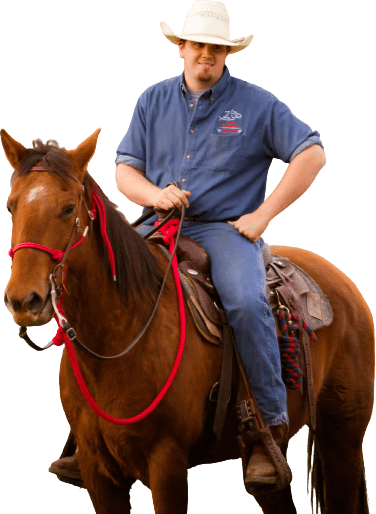 Man in a blue shirt and a cowboy hat riding a horse